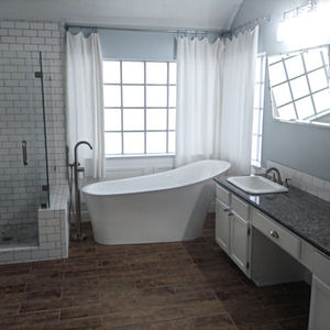 Modern bathroom with freestanding tub and glass shower.