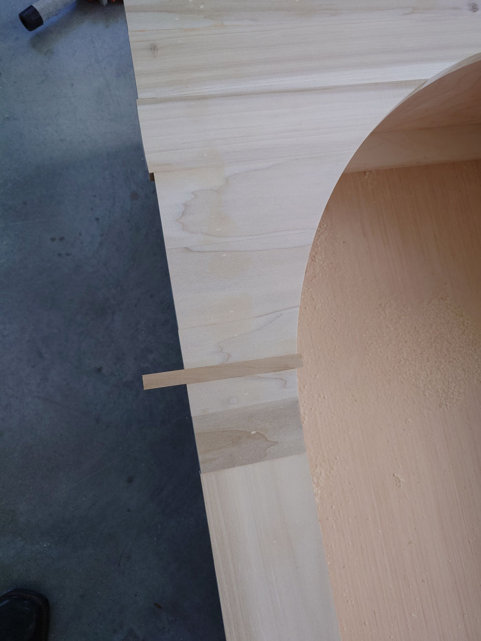 Wooden furniture piece with curved and straight edges.