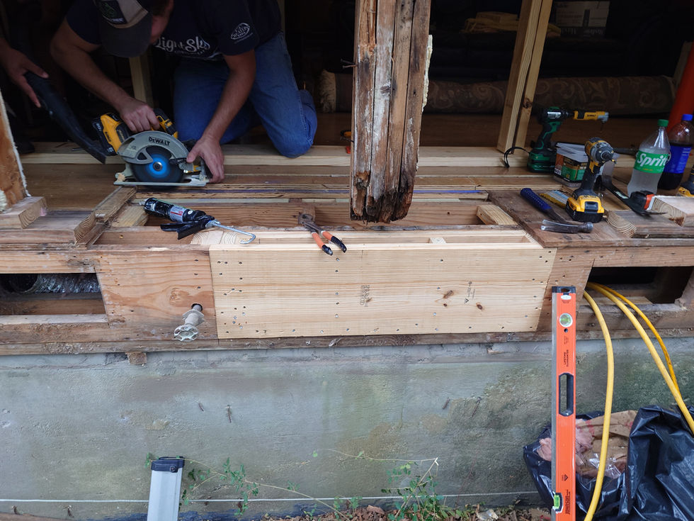 Person using a circular saw on wooden structure.