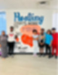 Group photo in from of Teen Support Center mural.