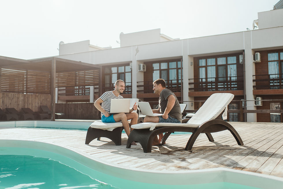 Two Men Sitting By Pool With Computes