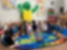 students raising hands in class