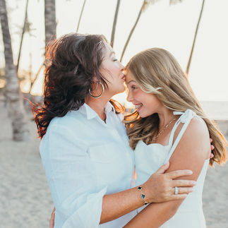 Dreamy family sunset beach photo session in Hawaii, wearing white, light clothing, breathtaking beach and palm trees, loving family