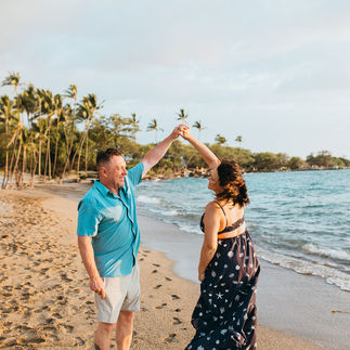 A couple dance on the beach in Hawaii, they are happy and in love