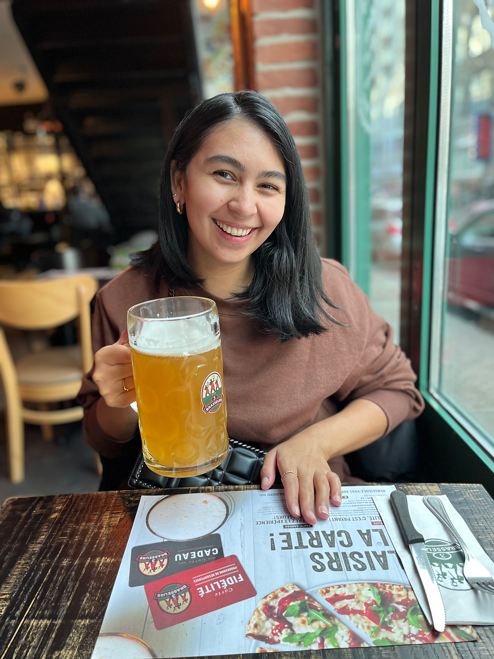 Smiling woman holding large beer mug at restaurant