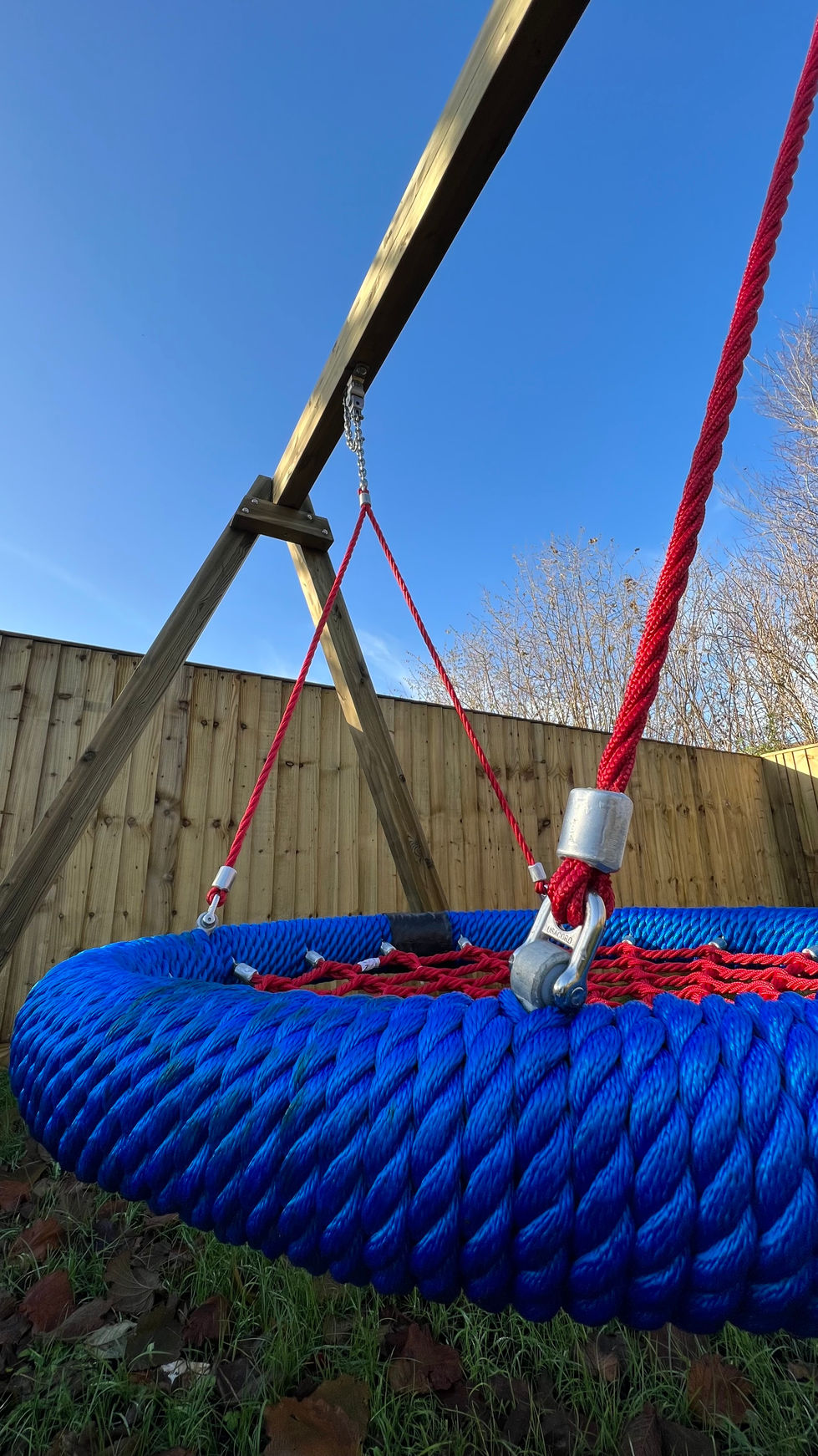 Outdoor Birdnest swing with red and blue net on stainless steel hangers on red rope