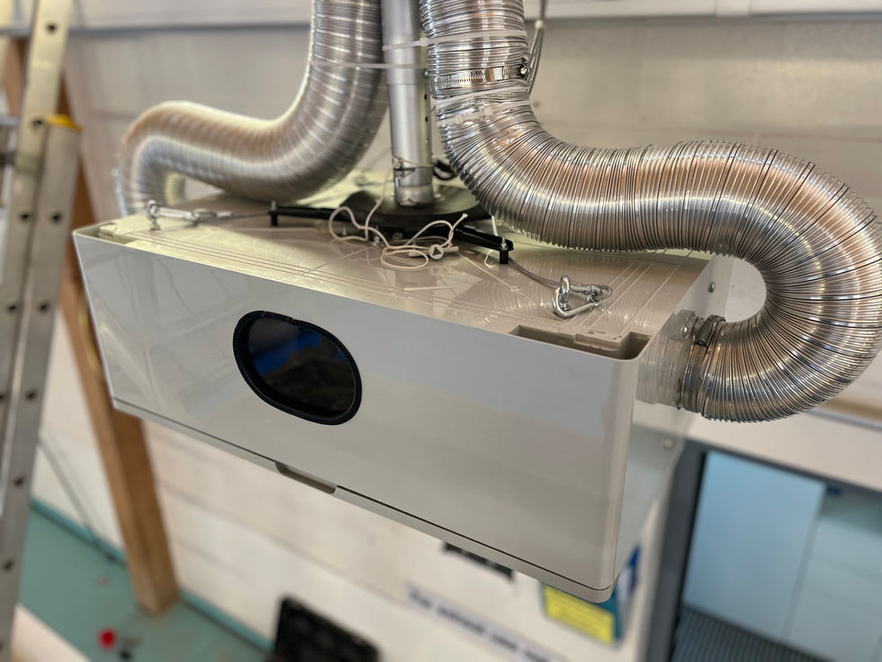 The IP 65 rated enclosure housing the 4K cinema projector hung on a bespoke handmade wall mount with the inlet and outlet ventilation system in place
