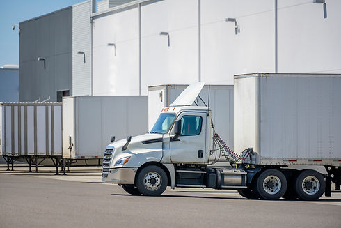Big rig local haul day cab industrial freight white semi truck with roof spoiler loading c