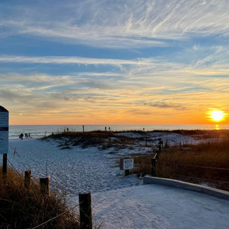 Sunset over the white sand beach and Gulf in Destin, Florida.