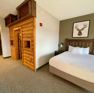 KidCabin themed family suite at Great Wolf Lodge with a log cabin sleeping area for children.