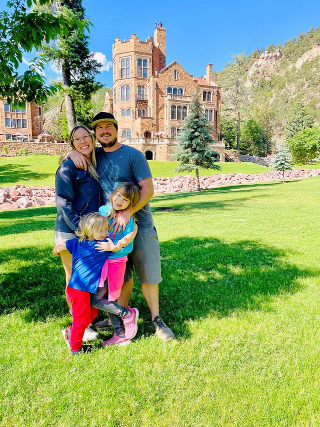 Family in front of Glen Eyrie Castle in Colorado Springs, Colorado.