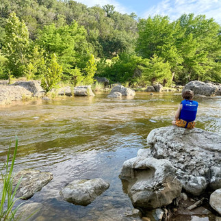 Child overlooking the designated swimming area at Pedernales Falls State Park.