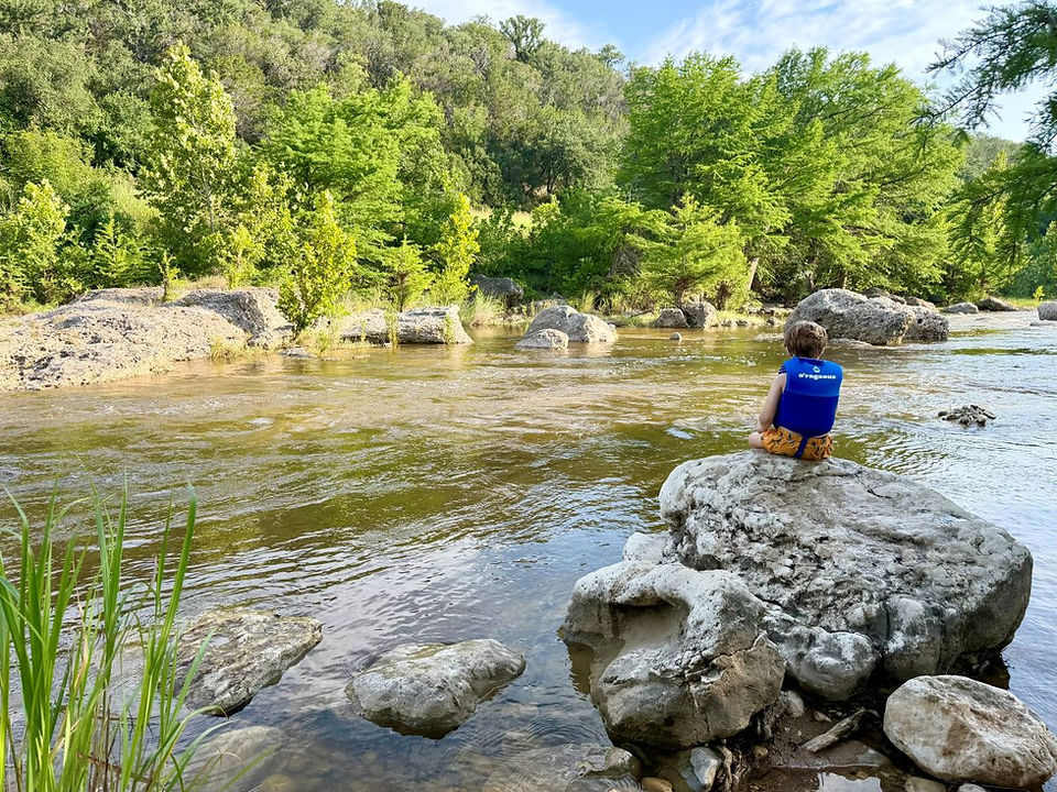 Child overlooking the designated swimming area at Pedernales Falls State Park.