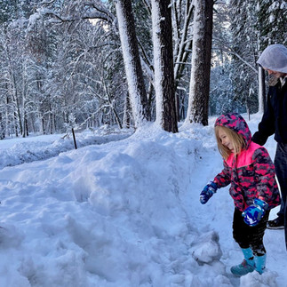 Child playing in fresh snow during a winter visit to Yosemite National Park.