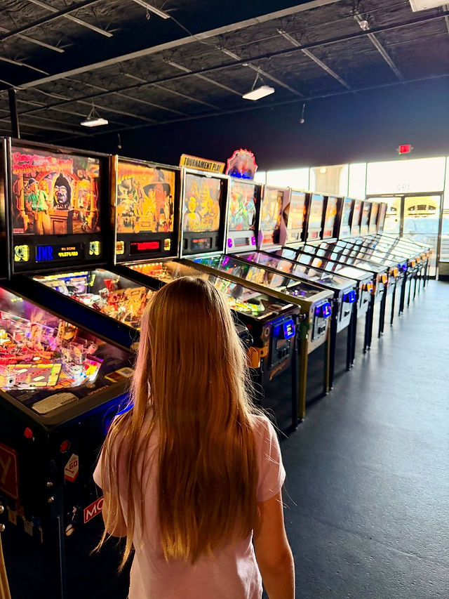 Rows of classic pinball machines at Push Start Play.