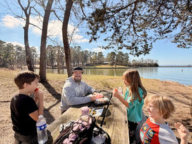 Family picnic at Lake Livingston State Park day use area in East Texas.