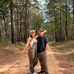 Jessica and Kevin wearing KÜHL KULTIVATR Overalls and Renegade Pants together on a wooded trail.
