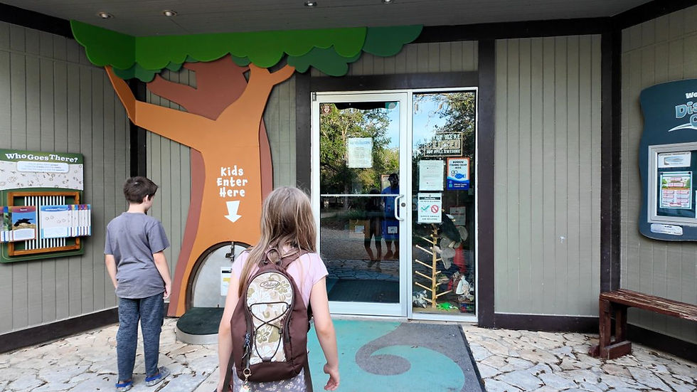 Discovery Center entrance at Guadalupe River State Park with a kid-sized door for children.