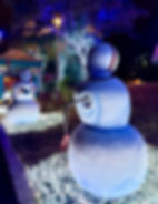 Football-themed snowmen decorations at SeaWorld San Antonio’s Christmas Celebration, including a snowman whose head is shaped like a football.