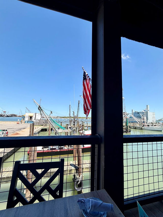 Waterfront view and fishing boats from the outdoor seating at Katie's Seafood House.