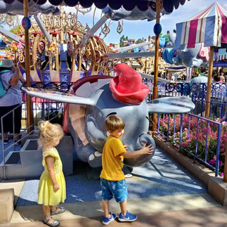 Children exploring the Dumbo attraction at Disneyland Park in California.