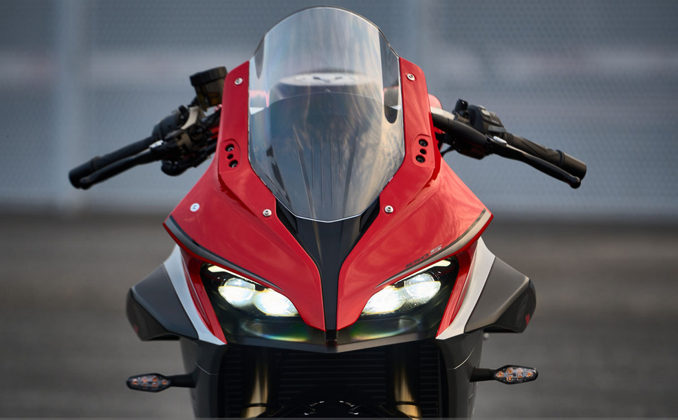 QJMOTOR SRK 600 RS: Die rote Front mit zwei eingeschalteten Scheinwerfern und hoher Scheibe.