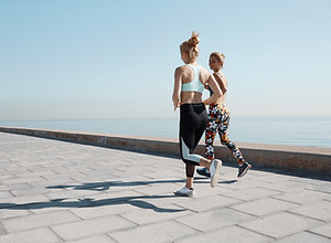 Two Girls Jogging by Water