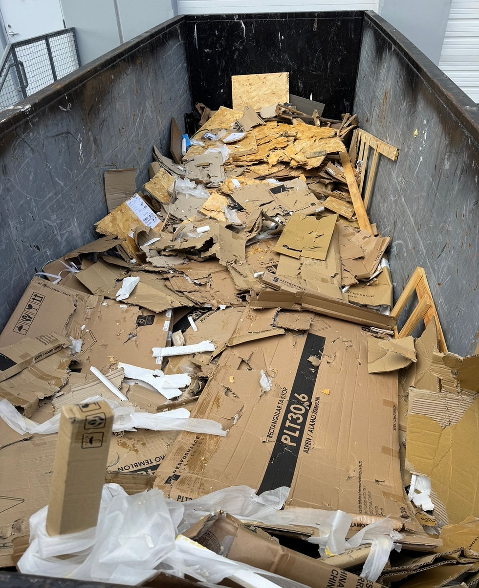 Cardboard and mixed waste in an open-top dumpster