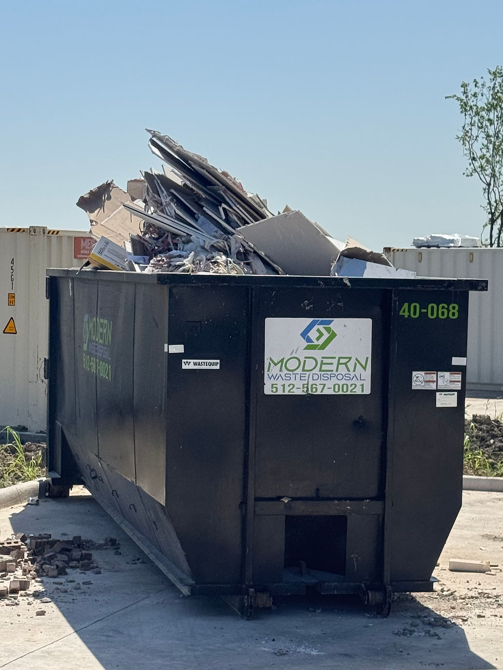 Overflowing roll-off dumpster with construction debris in Austin, Texas