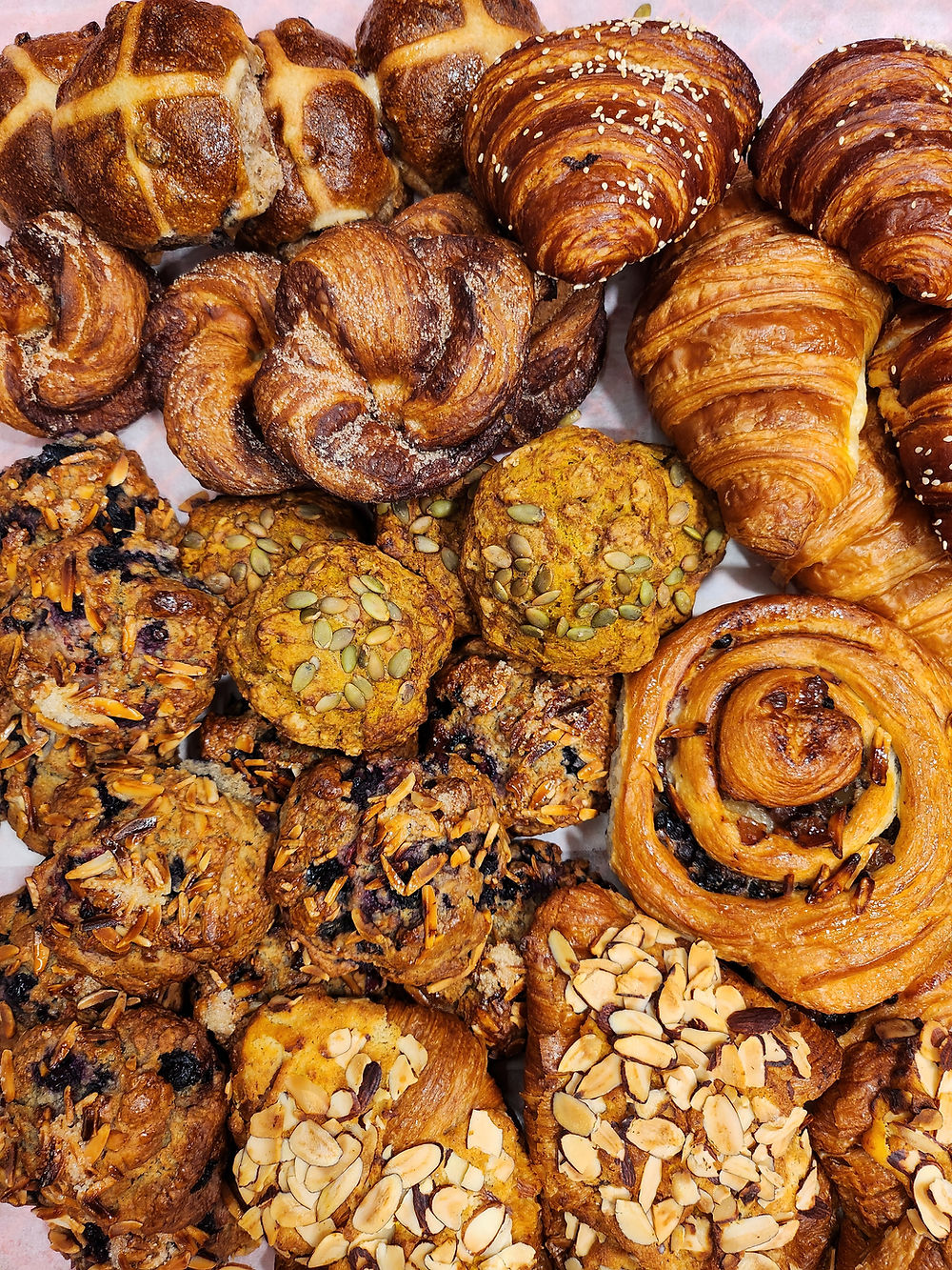 Croissants, muffins, hot cross buns, and cookies.