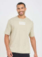 Man smiling, wearing beige "RESOLVE" graphic tee