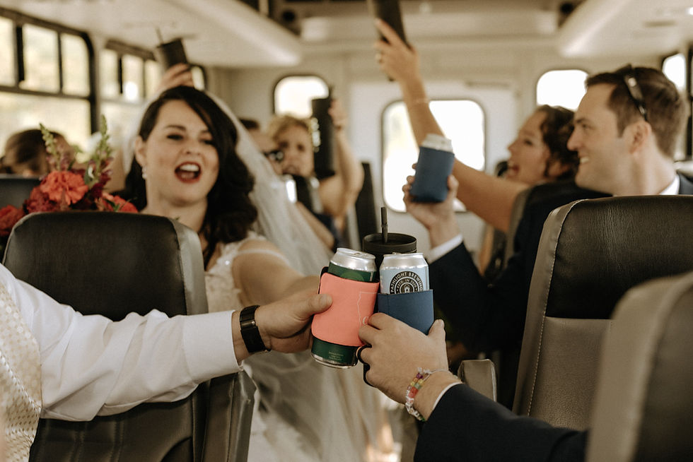 A wedding party toasts on a party bus