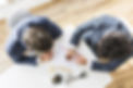 overhead-view-businessmen-working-company-financial-report-white-desk (1).jpg