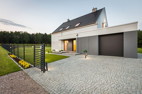 Stylish villa with fence, garage and stone driveway, external view.jpg