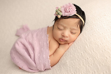 Newborn Photography Chadstone - Peaceful sleeping baby wrapped in soft blanket in professional studio