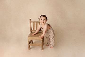 Baby Photography Chadstone - Adorable baby sitting up and smiling in a beautifully styled studio session
