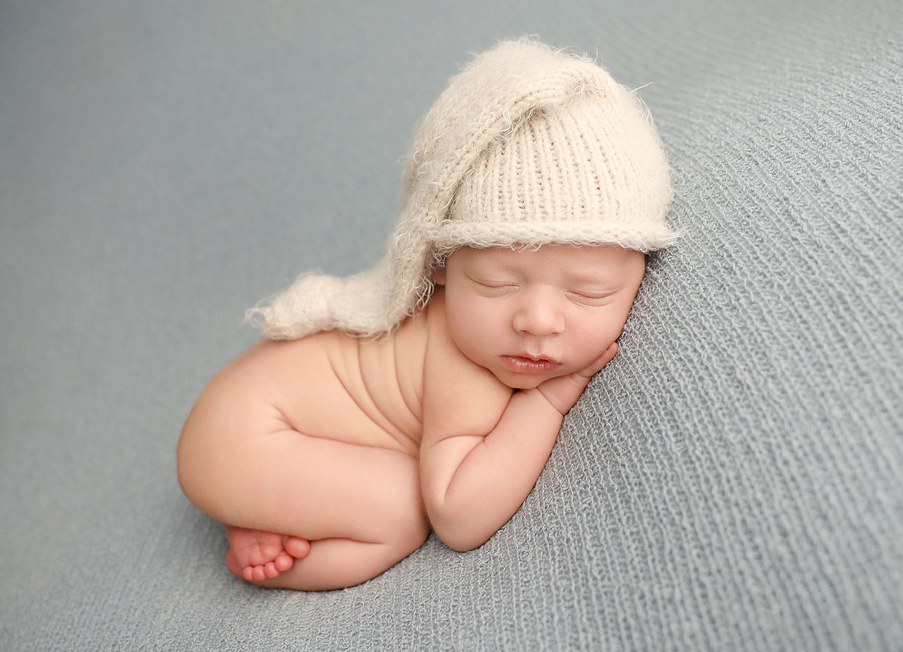 Baby boy newborn photography Melbourne with classic beanbag pose and neutral styling