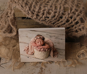 Examples of wall art options, including canvases and framed prints, displaying stunning newborn photography for home decor