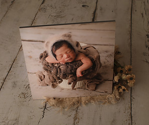Collection of elegant wall art featuring newborn photography, including framed prints and canvases