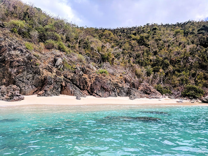 secluded private beach with aquamarine water