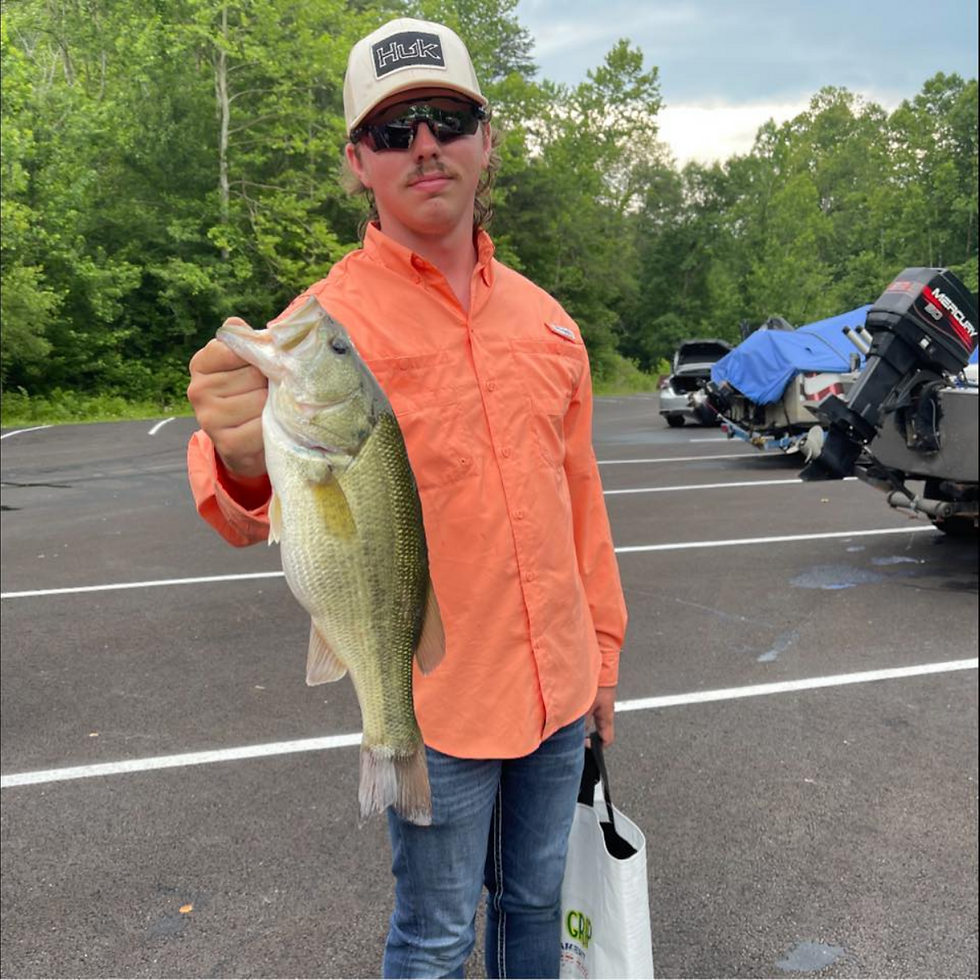 In this image, we see a proud angler showcasing a notable catch. Dressed in an orange shirt and sporting sunglasses and a cap, the owner embodies a moment of leisure and accomplishment away from the rigors of work, reflecting a personal connection to outdoor life and the simple pleasures it can bring.