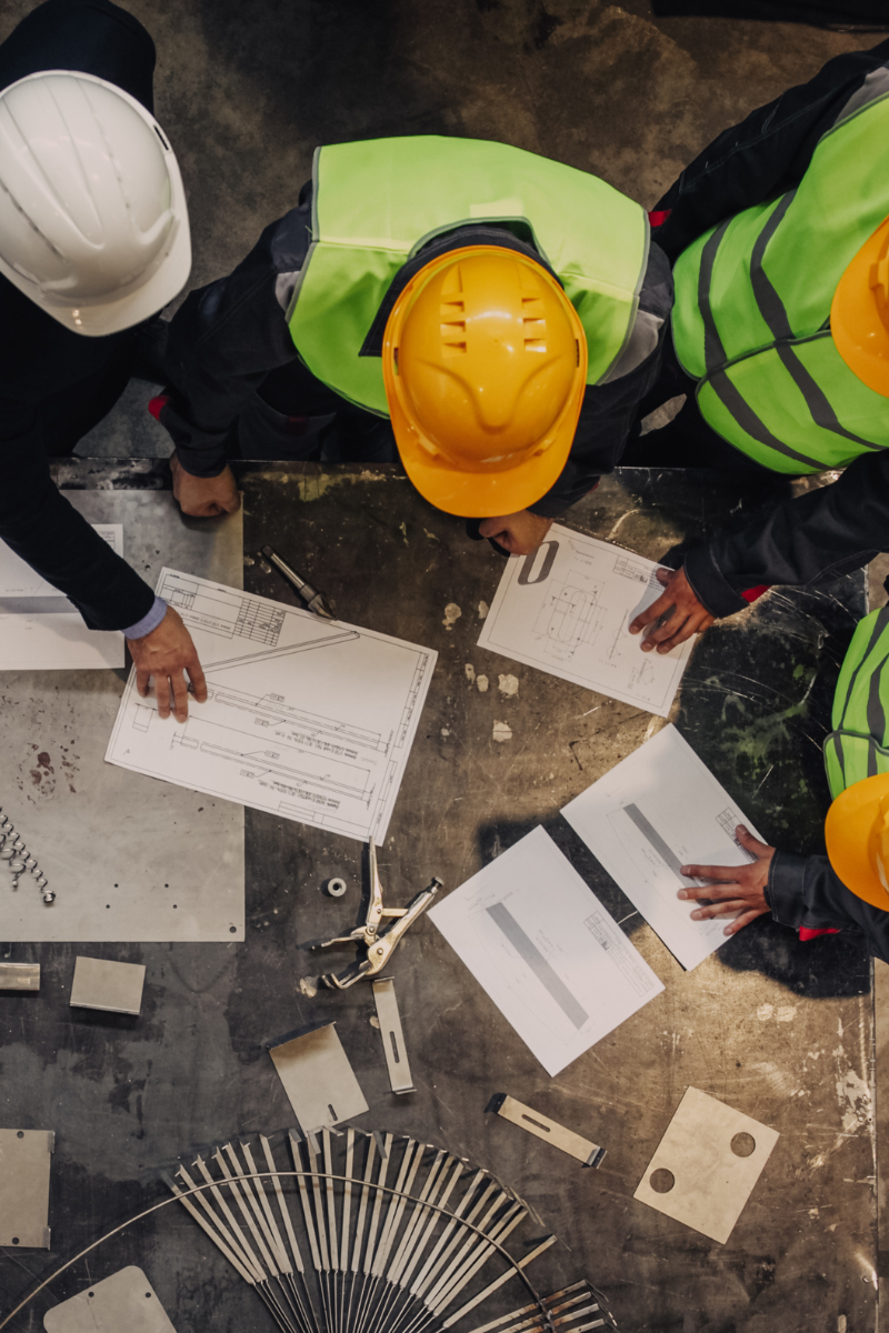 An image depicting a team of professionals discussing plans, emphasizing the benefits of professional excavation for home improvement projects. Ideal for illustrating the expertise and precision of professional excavation services.