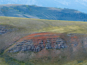 Layered rocky hills with sagebrush and muted autumn colors in the National Elk Refuge near Jackson, Wyoming.