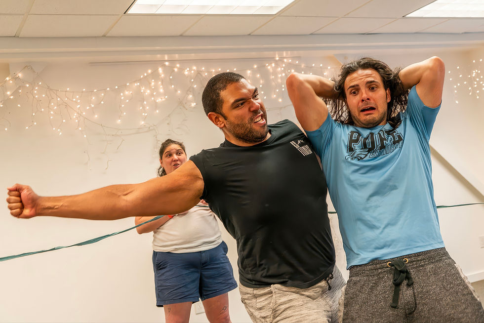 Shaquille Sinclair and Jordan Zakka rehearse their wrestling match while T Boris Schachter looks on. Photo taken by John Bendel.