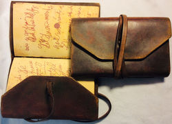 Aged brown leather journal with written pages in Spanish