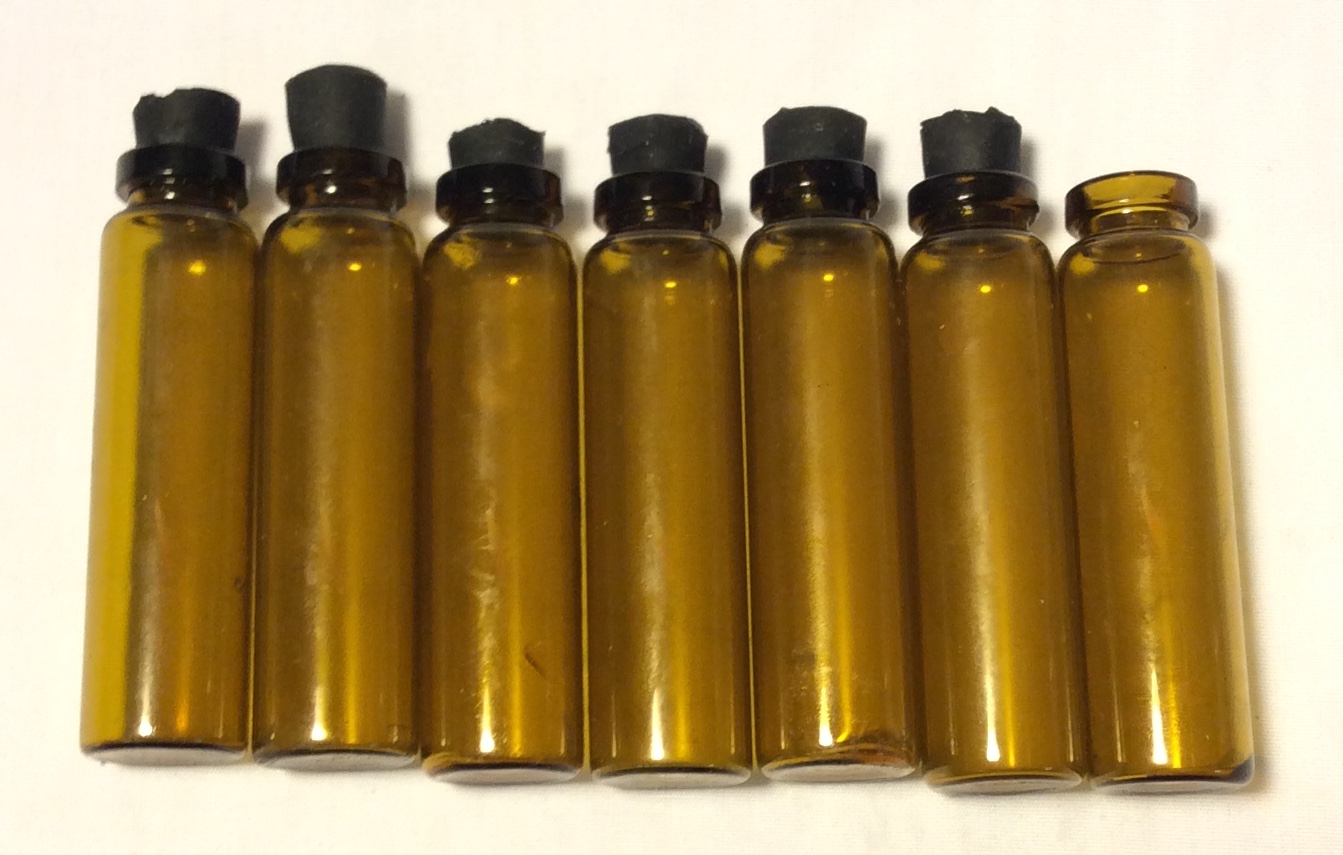 Small brown glass vials with black