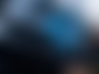 Mechanic using a digital diagnostic tablet to analyze a car engine, checking vehicle performance and system issues.