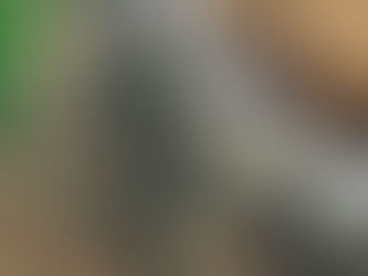 Erosion control project in Walton County, FL showing a newly built rock retaining wall beside a home under construction, designed to stabilize soil and prevent erosion on the property.