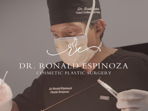 Dr. Ronald Espinoza performing cosmetic plastic surgery in NYC wearing surgical attire and magnification lenses