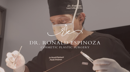 Dr. Ronald Espinoza performing cosmetic plastic surgery in the operating room, wearing surgical attire and gloves